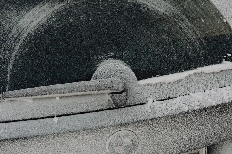 A car door and window frosted over after a cold night